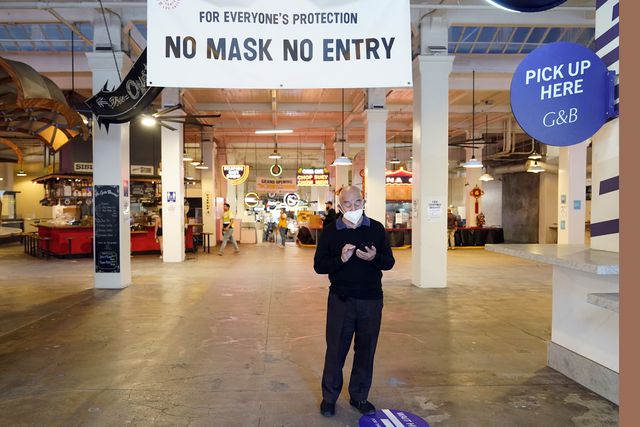 Sign points to a mask mandate at the Grand Central Market, in Los Angeles.